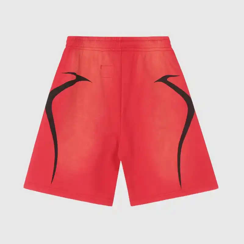 Introducing the Hellstar Warm Up Shorts 'Red': these shorts feature a vibrant red color with a striking black abstract design on each side set against a plain background. They're perfect for your pre-game routine or casual outings.