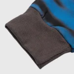 Close-up view of the ribbed cuff detail on the Hellstar Classic Logo Airbrush Zip-Up hoodie in blue and black fabric.