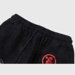 Close-up of the elastic waistband and drawstring detail on the black Hellstar Airbrushed Skull Flare Sweatpants.