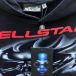 Close-up view of the Hellstar Airbrushed Skull Hoodie featuring the brand tag and signature black clothing label.