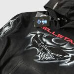Hellstar black hoodie featuring a detailed airbrushed skull graphic and red brand lettering for a unique streetwear look.