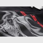 A close-up view of the airbrushed skull graphic and red brand lettering on a vintage black Hellstar streetwear hoodie.