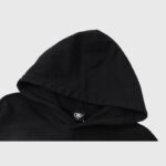 Close-up view of the hood on a black Hellstar Airbrushed Skull Hoodie featuring branded interior neck labeling.