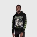 Model wearing a black Hellstar Amen print fleece hoodie with graphic screen print details on the chest and sleeves.