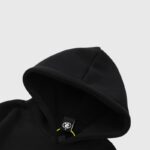 A close-up detail of the black fleece Hellstar Amen Print Hoodie featuring a soft hood and interior brand tag.