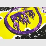 Close-up view of the Hellstar Amethyst T-Shirt graphic print with a purple flame design on a vibrant yellow background.