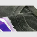 Close-up of the vintage washed cotton fabric and screen print design on the black Hellstar Amethyst Unisex T-Shirt.