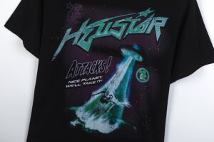 Hellstar Attacks Hypnotic Vision black t-shirt featuring a green graphic of a UFO alien invasion and text.