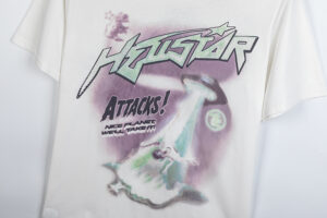 Hellstar Attacks Hypnotic Vision graphic print on a white t-shirt featuring a retro UFO alien invasion design