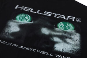 Hellstar Attacks Hypnotic Vision Tee in black with a vintage washed graphic featuring swirling green hypnotic eyes print.