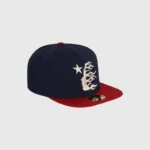 A dark blue Hellstar baseball fitted hat featuring an embroidered white star and flame logo on the front panel.