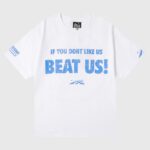 Hellstar "Beat Us!" white cotton t-shirt with distressed blue front slogan and small flame logo, made in Los Angeles
