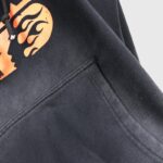 Close-up of the Hellstar If You Don’t Like Us Beat Us tracksuit hoodie with signature flame graphic and drawstring.