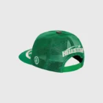 Green Hellstar trucker snapback hat with a big logo, mesh back, and adjustable snap closure design from the side angle