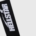 A close-up view of the Hellstar Black Classic Socks featuring the signature white logo branding on premium cotton.