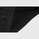 Close-up view of the ribbed hem detail on a black Hellstar crewneck sweatshirt showing the fabric texture and quality.