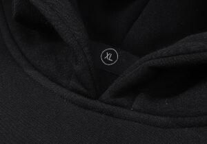 Closeup detail of the Hellstar Black Hoodie neck area showing the size XL label on the soft premium fabric garment.