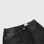 Hellstar black washed denim jeans featuring a classic button closure and signature brand logo tag on the waist.