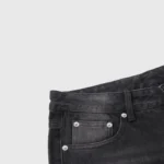 Detailed close-up view of the waist and front pocket of Hellstar black washed denim jeans featuring metal rivets.