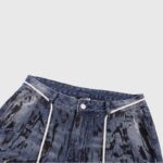Hellstar premium blue denim jeans featuring a unique black paint splatter graphic print and durable construction