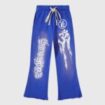Hellstar blue yoga sweatpants with white flame and tribal prints, drawstring waistband and vintage washed fleece design