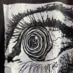 Close-up graphic print of the Hellstar Brainwashed black T-shirt featuring a detailed artistic eye design