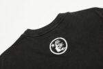 Close-up of the Hellstar Brainwashed Black T-shirt showing the white graphic logo detail on the premium cotton fabric.