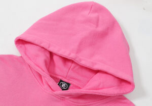 Detailed view of the pink Hellstar Brainwashed hoodie focusing on the hood design and inner brand label tag.