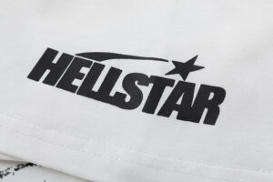 Close-up view of the black Hellstar logo printed on a white Brainwashed T-shirt fabric for a premium streetwear look.