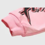 Close-up of the Hellstar Brainwashed With Brain hoodie in pink showing the graphic print detail on the sleeve cuff.