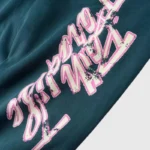 Close-up view of the unique graphic screen print detail on the dark green Hellstar Capsule 8 Paradise sweatpants.
