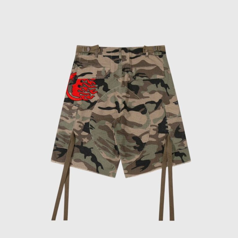 Back view of Hellstar camo cargo shorts featuring tactical utility pockets, decorative straps, and red branding details.