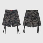 Front and back view of Hellstar cargo shorts in camo print, featuring cargo pockets, raw hems, and long hanging straps.