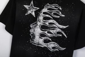 Close-up view of the black Hellstar Chrome logo t-shirt featuring a detailed silver star and flaming moon graphic.