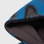 Close-up of the Hellstar Classic Logo Airbrush Zip-Up hoodie hood, featuring blue and black vintage-style fabric details.