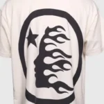 A premium white Hellstar classic cotton t-shirt featuring a bold black graphic print of a flaming face and a star.