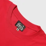 A detailed close-up shot of the interior collar tag on a bright red Hellstar Crack Print graphic streetwear t-shirt.