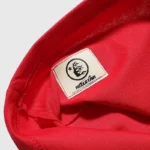 Close-up view of the authentic Hellstar Crack Print T-shirt label featuring the brand logo and NFC authentication tag.