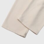 Close-up view of the cream Hellstar If You Dont Like Us Beat Us sweatpant ankle hem and fabric texture detail.