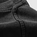 Close up of the premium black cotton fabric used for the Hellstar Crochet Jesus T-shirt streetwear design.
