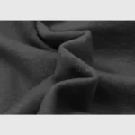 Close-up view of the premium black cotton-blend fleece fabric used for the Hellstar Crying Baby graphic hoodie.