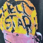 Detailed view of the Hellstar Dennis Rodman graphic design on a vintage washed black streetwear cotton t-shirt.