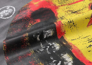 Close-up view of the bold yellow and red graphic print featured on the Hellstar Evil Smile t-shirt fabric detail.