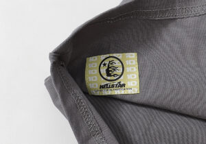 Close-up view of the Hellstar Evil Smile T-Shirt inner neck tag label with branding and authentication details.