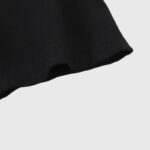 Close-up view of the premium heavyweight black cotton fabric sleeve on the authentic Hellstar Eye graphic T-shirt.