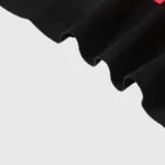 Closeup of the black premium cotton fabric texture from the Hellstar Family Letter Printed T-Shirt design.