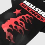 Close-up view of the black Hellstar graphic t-shirt featuring bold red flame and lettering screen print design.