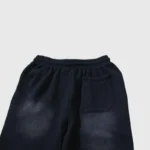A close-up view of the back of black Hellstar Fire elastic sweatpants showcasing the pocket detail and fabric texture.