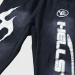 Black Hellstar Fire elastic sweatpants featuring a bold white screen-printed flame graphic on the front leg design.