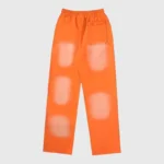 Back view of orange Hellstar Fire elastic sweatpants with unique washed-out details and a comfortable waistband.